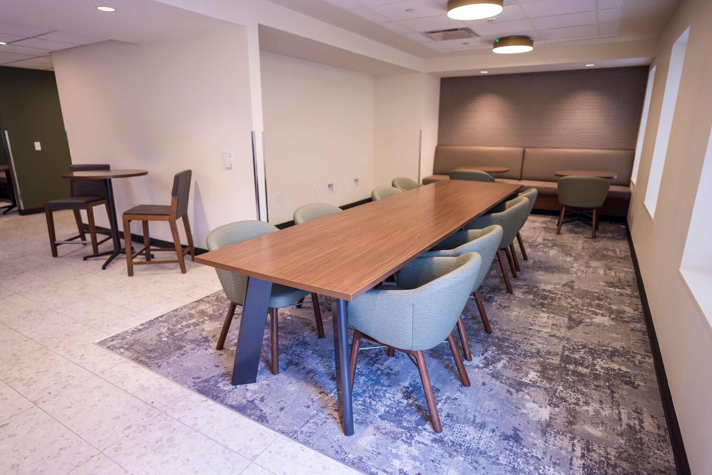 View of the second floor dining table near the Community Kitchen and some other smaller seating.