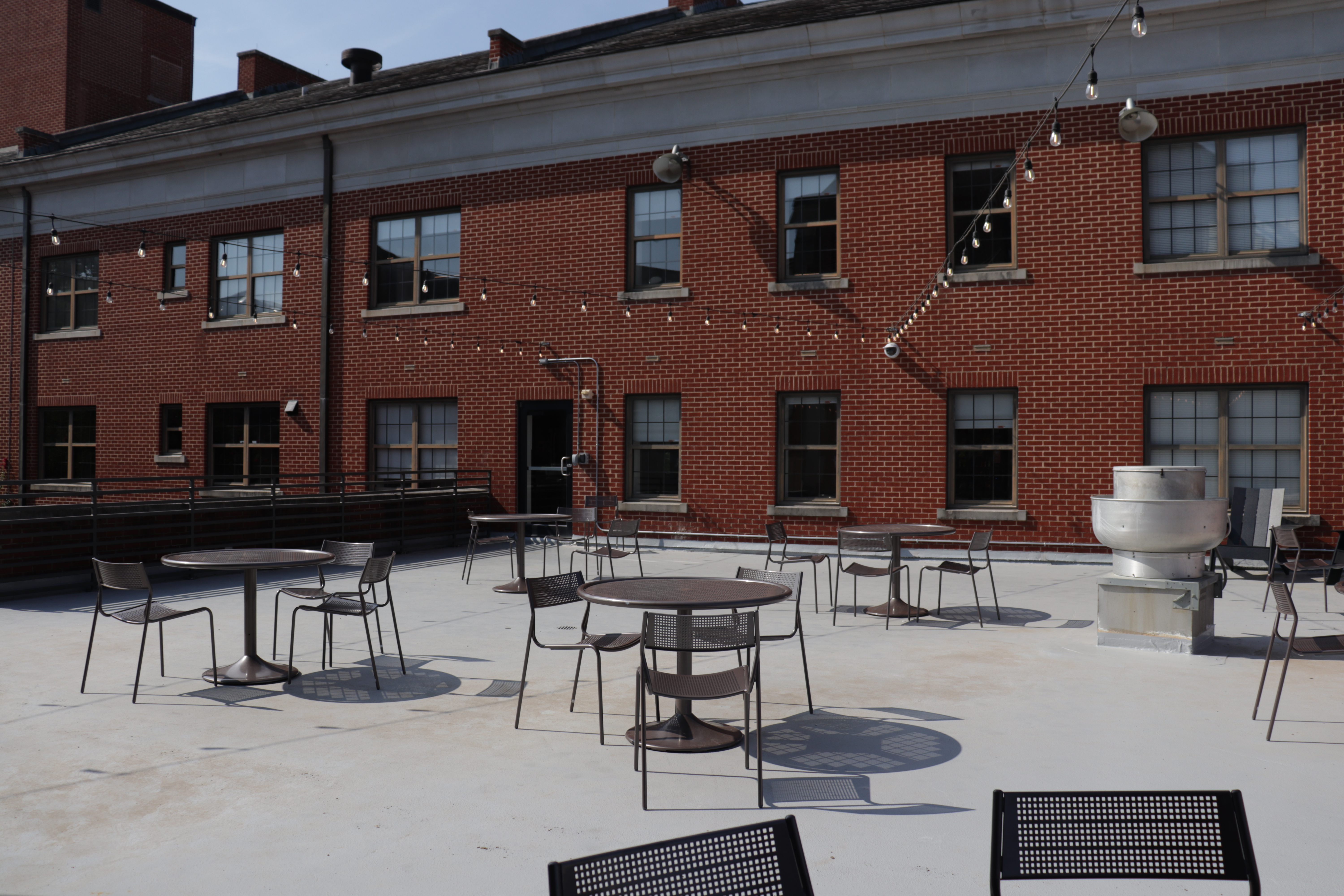 More tables and chairs on the Dawson-Memorial Terrace. Facing the outside of the Commons of LEAD LLC.