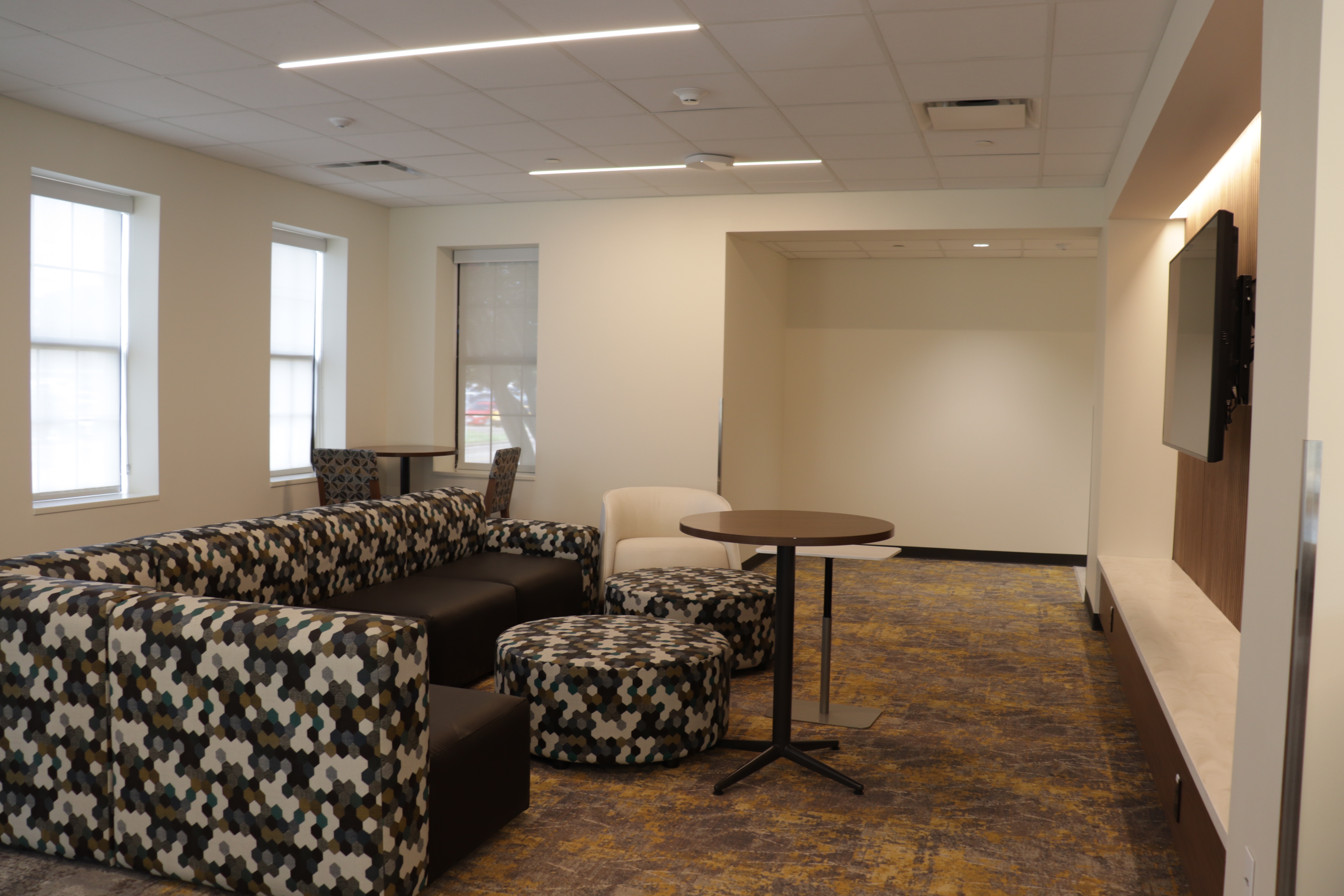 Allen lobby couch, chairs, tables, and TV.