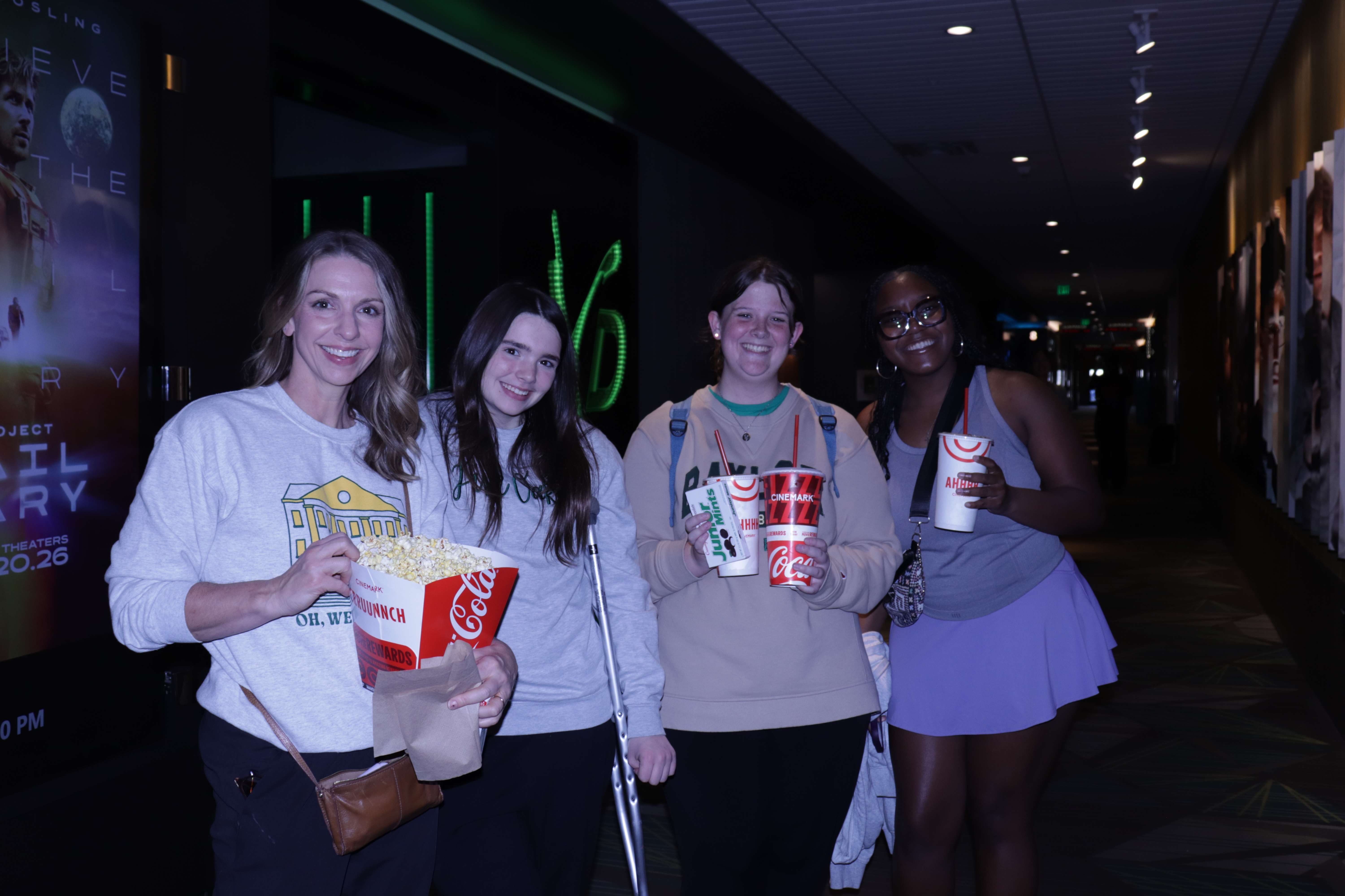 Dr. Johnston with her daughter and some other students at Cinemark Movie Night.